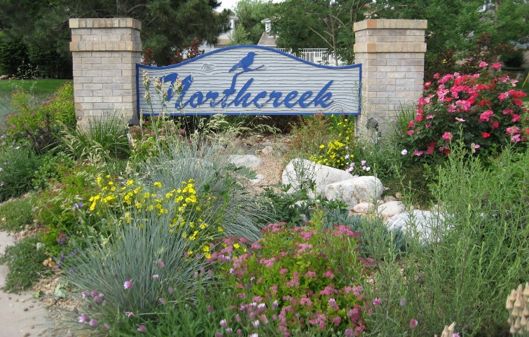 The Northcreek entrance sign with the flower bed in bloom